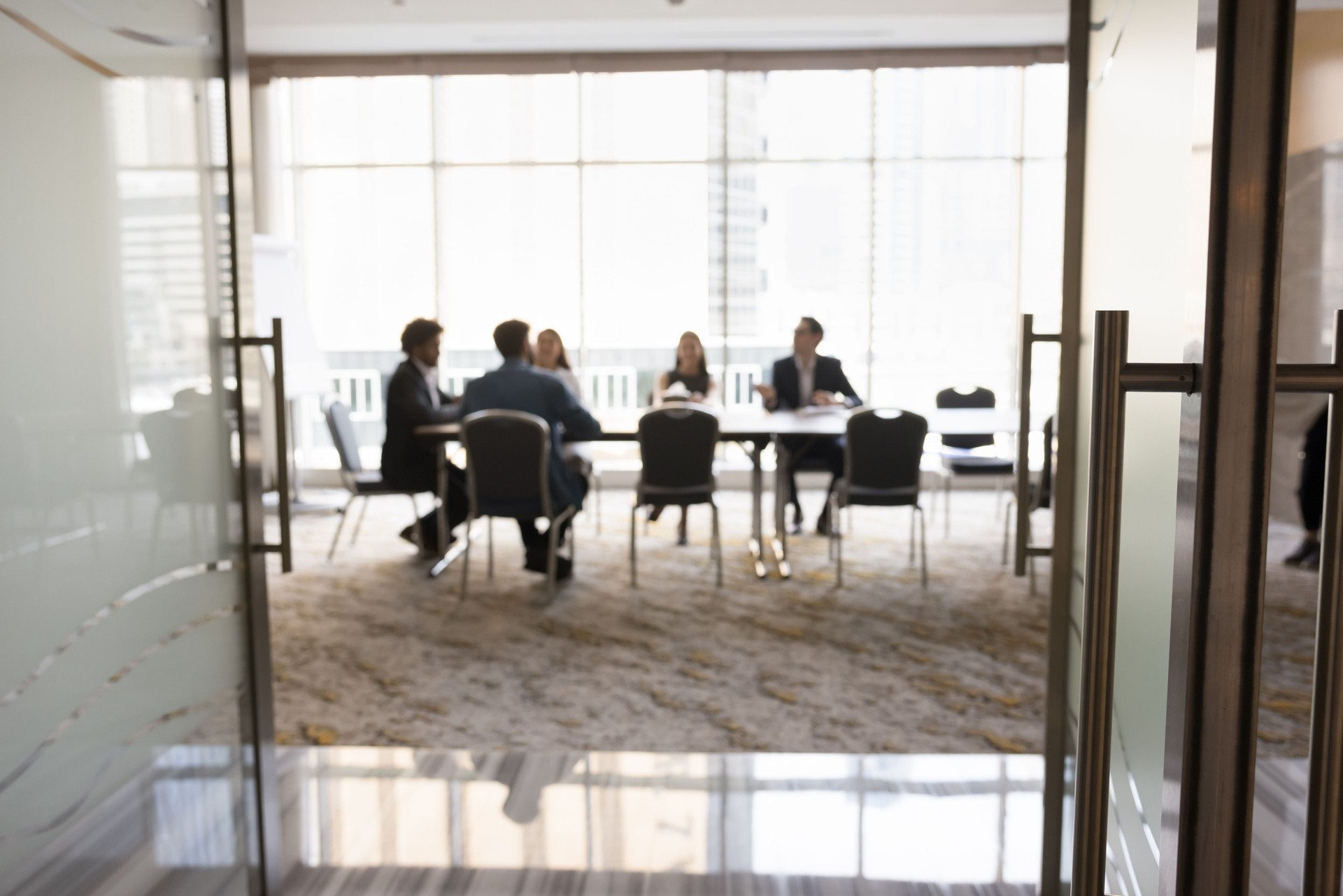 Group of businesspeople sitting at large conference table